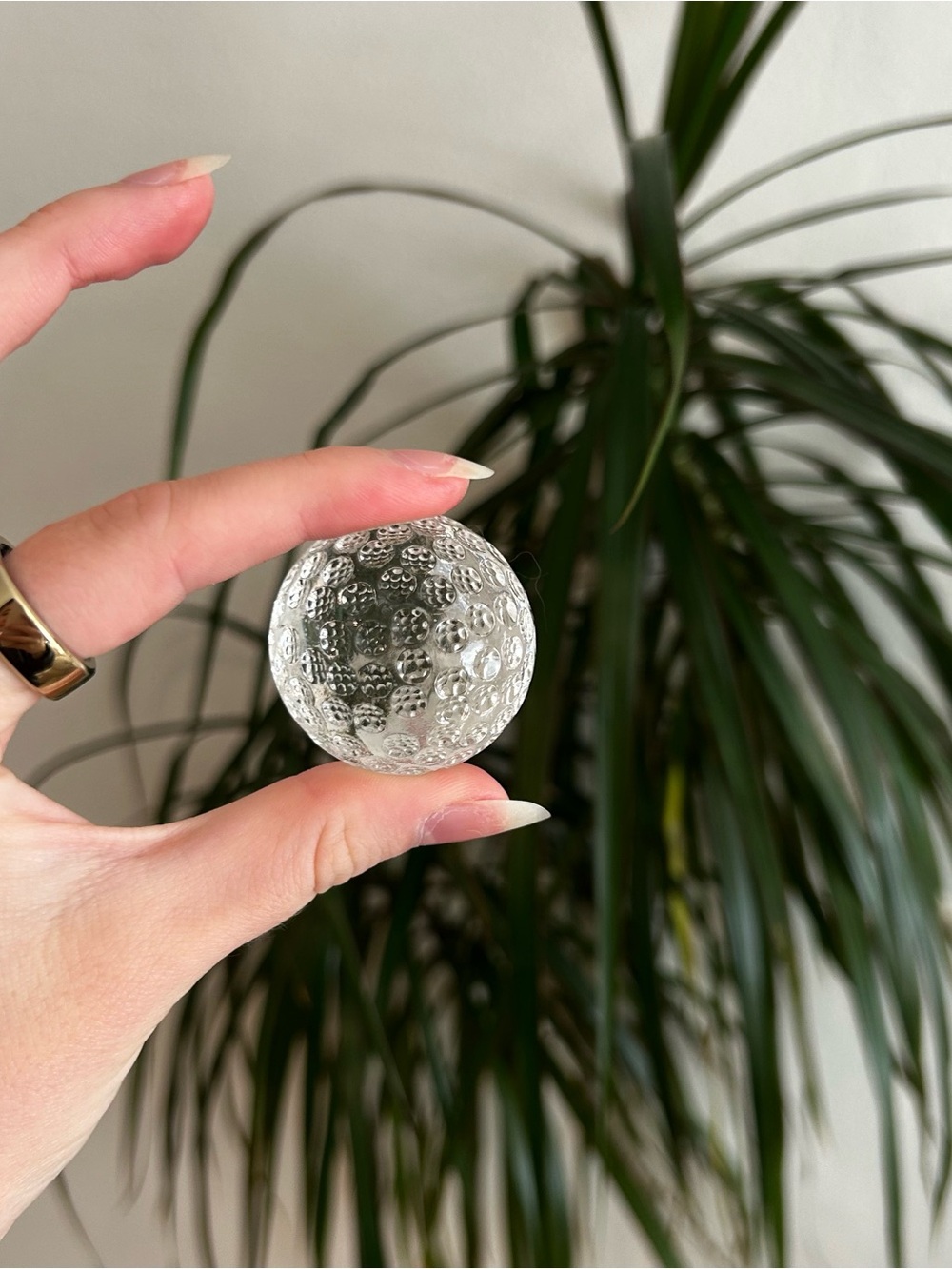 Glass paperweight golf ball with dimpled texture
